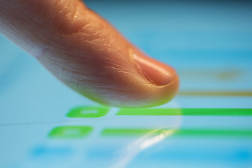 Image showing close up of hand using computer touch screen