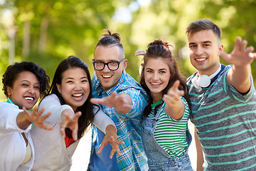 Image showing happy smiling friends having fun in park