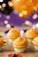 Image showing cupcakes with halloween decoration on table