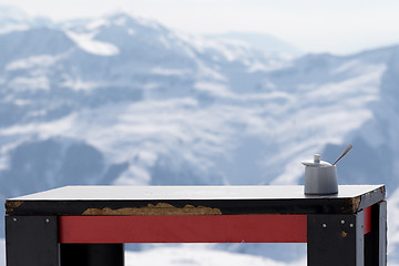 Image showing Old table with sugar bowl in outdoor cafe at ski resort