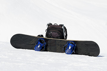 Image showing Snowboard and backpack on ski slope