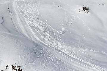 Image showing Snow off-piste slope with traces of skis and snowboards