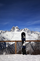 Image showing Snowboards in outdoor cafe at ski resort at sun winter day