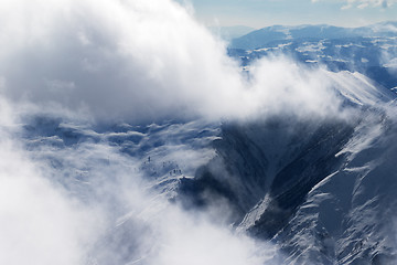 Image showing Winter snow mountains in sunlight clouds