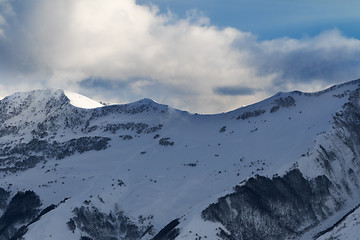 Image showing View on off-piste slope with forest and sunlight sky with clouds