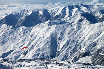 Image showing Paragliding at snow mountains over ski resort