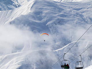 Image showing Chair-lift and paraplane on ski resort at cold winter day