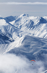 Image showing Paragliding at snow mountains in haze