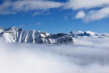 Image showing Snow sunlight mountains in fog at nice sun day