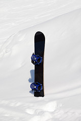 Image showing Snowboard in snowdrift after snowfall