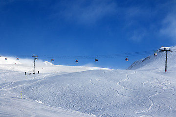 Image showing Gondola lift and off-piste ski slope in fog 