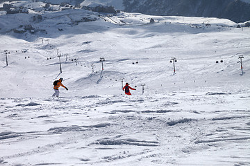 Image showing Two snowboarders downhill on freeride trace