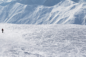 Image showing Snowboarder downhill on snow off-piste slope