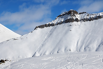 Image showing Off-piste slope with traces of skis, snowboards and avalanches