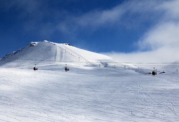 Image showing Gondola and chair lifts on ski resort at winter evening with sno