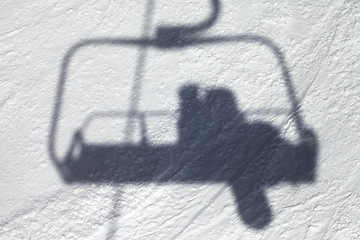 Image showing Shadows from chair lift with snowboarder 