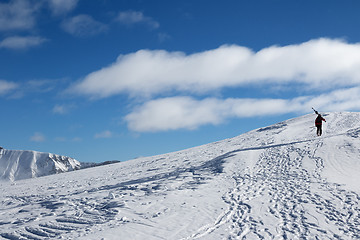 Image showing Skier with skis go up to top of mountain