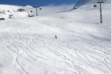 Image showing Skiers downhill on ski slope 