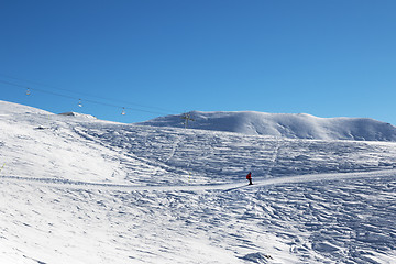 Image showing Skier downhill on ski slope at nice sun morning