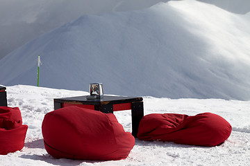 Image showing Bean bag chairs and table in outdoor cafe at ski resort 