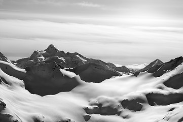 Image showing Black and white snowy mountains in evening