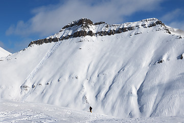 Image showing Skiers and off-piste slope with traces of skis, snowboards and a