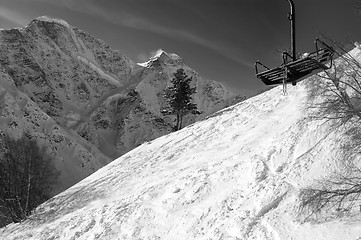 Image showing Black and white view on old chair lift and off-piste ski slope