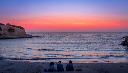 Image showing Three friends looking to the sunrise