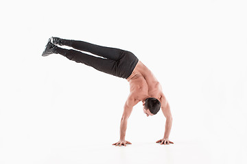 Image showing The group of gymnastic acrobatic caucasian men on balance pose