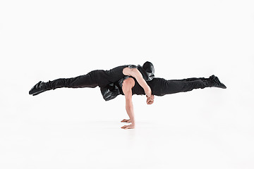 Image showing The group of gymnastic acrobatic caucasian men on balance pose