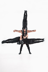 Image showing The group of gymnastic acrobatic caucasian men on balance pose