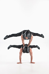 Image showing The group of gymnastic acrobatic caucasian men on balance pose