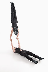 Image showing The group of gymnastic acrobatic caucasian men on balance pose