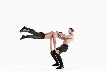 Image showing The group of gymnastic acrobatic caucasian men on balance pose