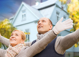 Image showing happy couple over living house in autumn