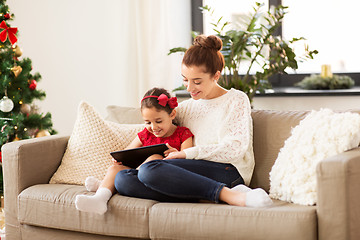 Image showing mother and daughter with tablet pc at christmas