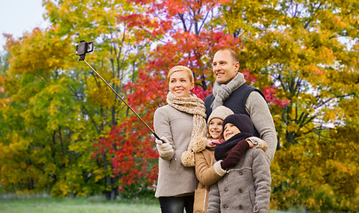 Image showing family taking selfie over autumn park background