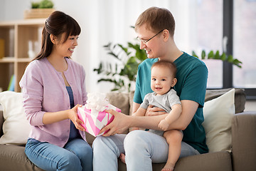 Image showing happy family with gift and baby boy at home