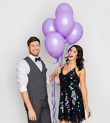 Image showing happy couple with ultra violet balloons at party