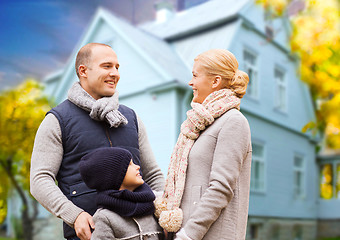 Image showing happy family over living house in autumn