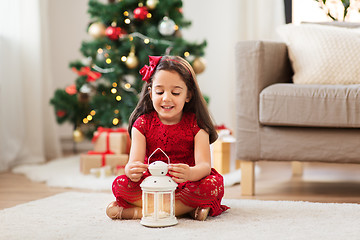 Image showing little girl with lantern at home on christmas