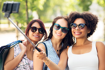 Image showing women with shopping bags taking selfie outdoors