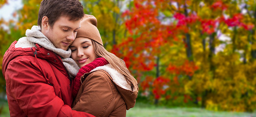 Image showing happy teenage couple hugging in autumn park