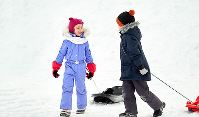 Image showing happy little kids with sleds in winter