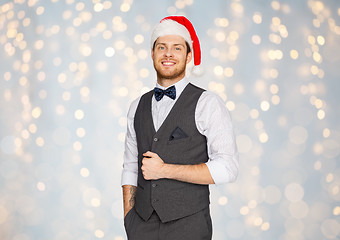 Image showing happy man in santa hat and suit on christmas