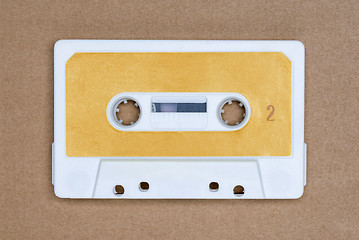 Image showing Retro white audio tape with yellow label on brown background. Side 2.