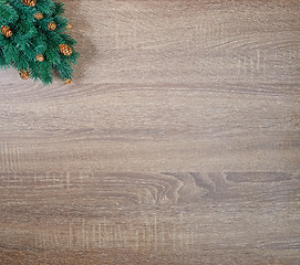 Image showing Christmas tree on brown wooden texture background.