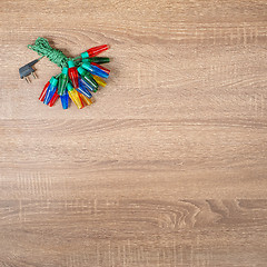 Image showing Christmas colorful lights on brown wooden background.