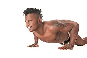 Image showing Muscular young man doing press-ups