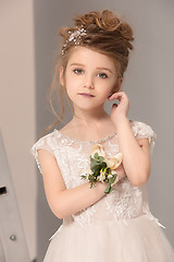 Image showing Little pretty girl with flowers dressed in wedding dresses